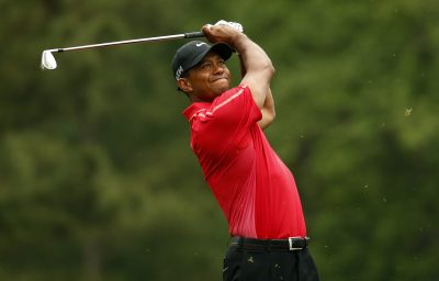 GOLF - THE MASTERS - PGA TOUR - 2015 Apr 12, 2015; Augusta, GA, USA; Tiger Woods hits his tee shot on the 12th hole during the final round of The Masters golf tournament at Augusta National Golf Club. Mandatory Credit: Rob Schumacher-USA TODAY Sports *** Local Caption ***