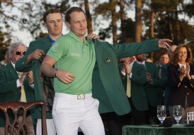 GOLF - PGA - MASTERS - 2016 Apr 10, 2016; Augusta, GA, USA; Danny Willett is helped into the green jacket by Jordan Spieth after Willett won the 2016 The Masters golf tournament at Augusta National Golf Club. Mandatory Credit: Rob Schumacher-USA TODAY Sports *** Local Caption ***